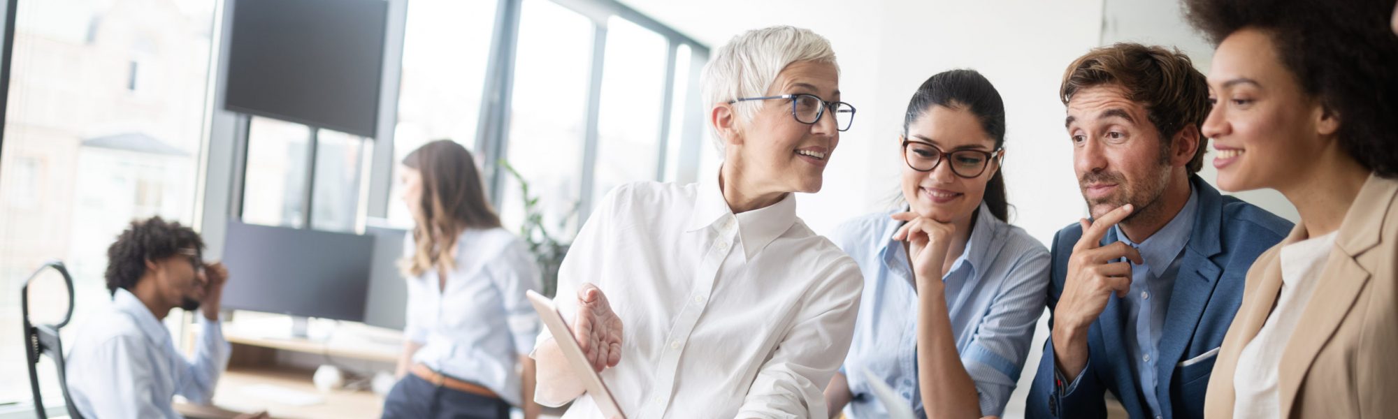 Group of successful happy business people at work in office