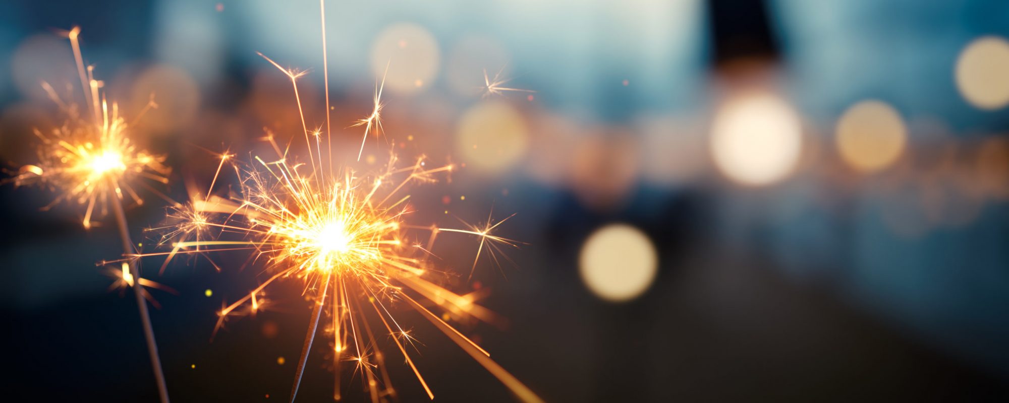 Burning sparkler with bokeh light background