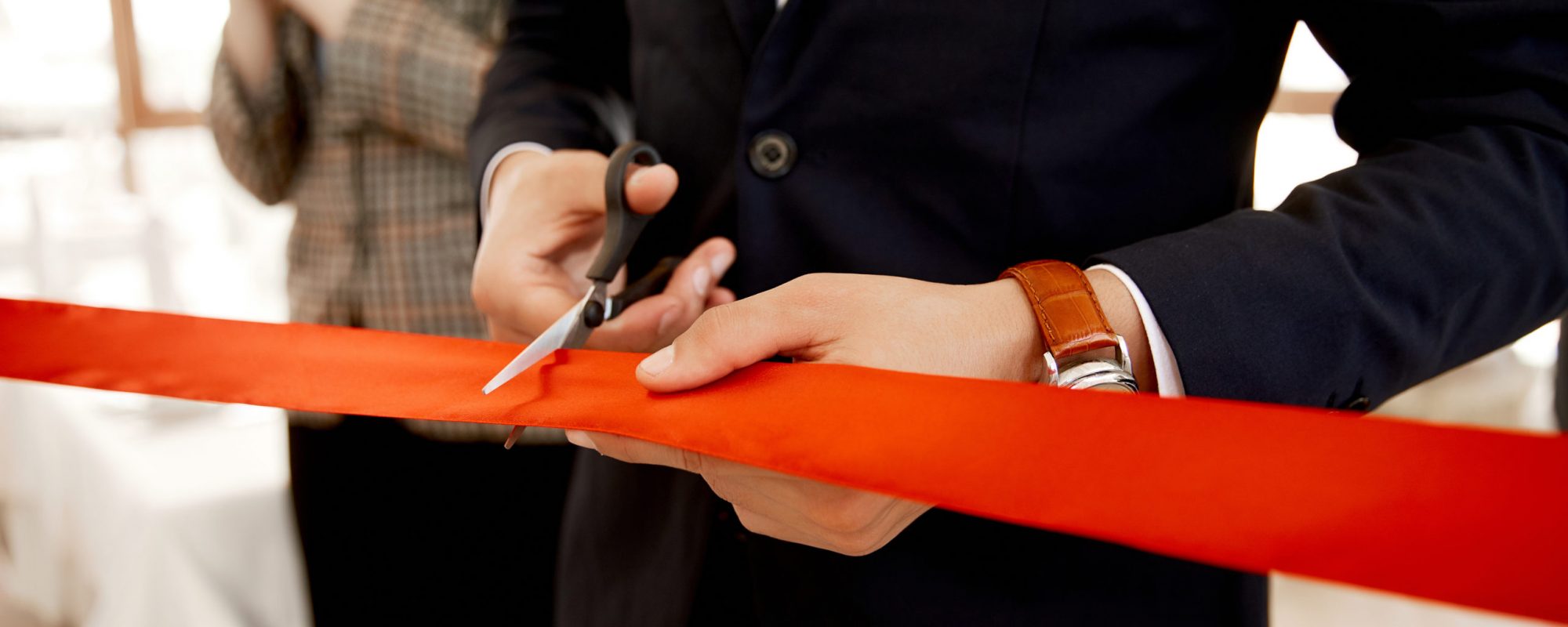 Front view of the cutting the red ribbon on the grand opening of the building