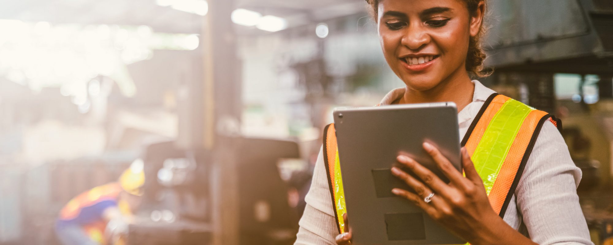 Industry maintenance engineer woman dark skin wearing uniform and safety helmet under inspection and checking production process on factory station by tablet. Industry, Engineer, construction concept.