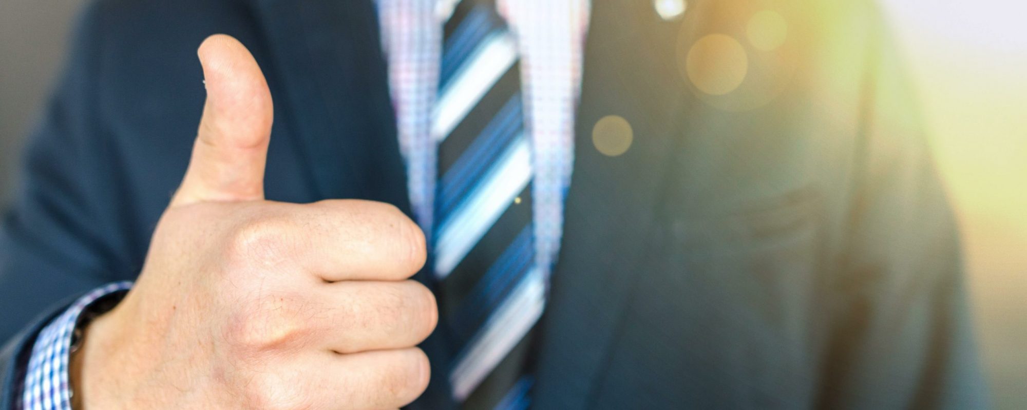 Midsection Of Businessman Showing Thumbs Up