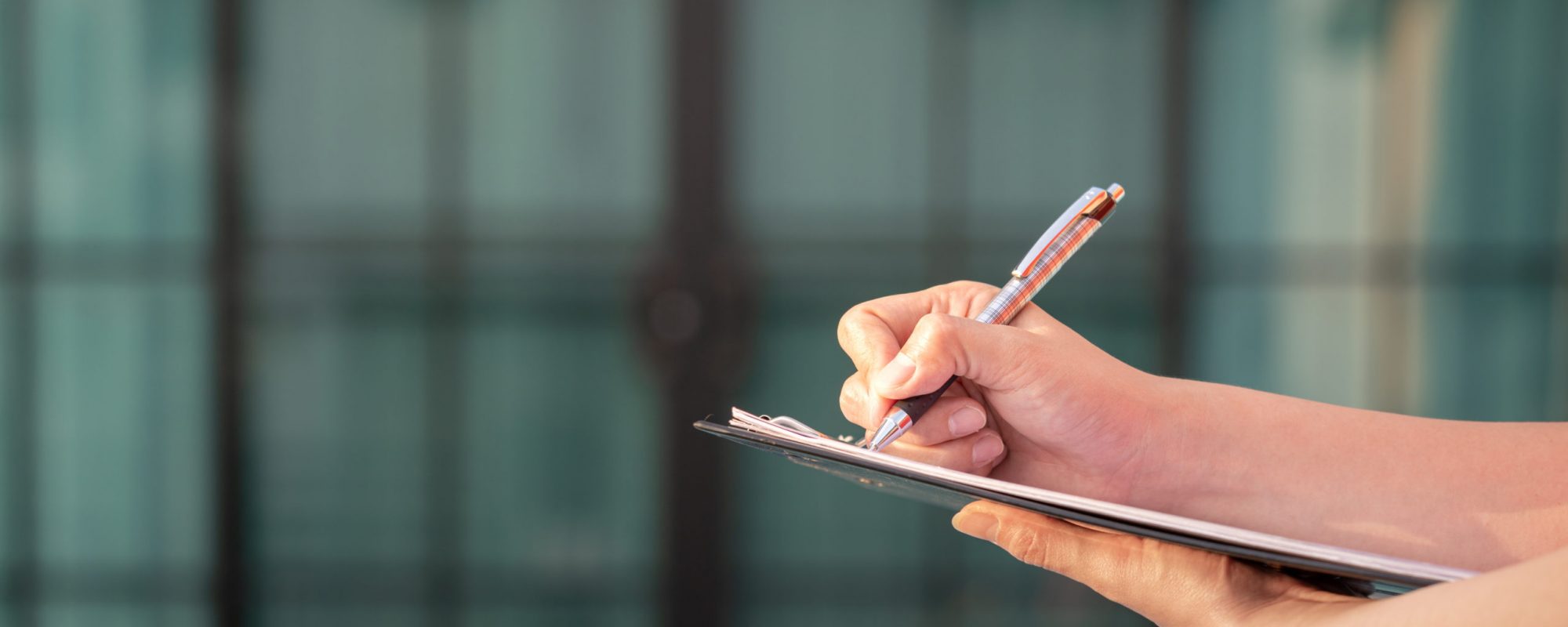 Action of an engineer is writing down on the clipboard paper to