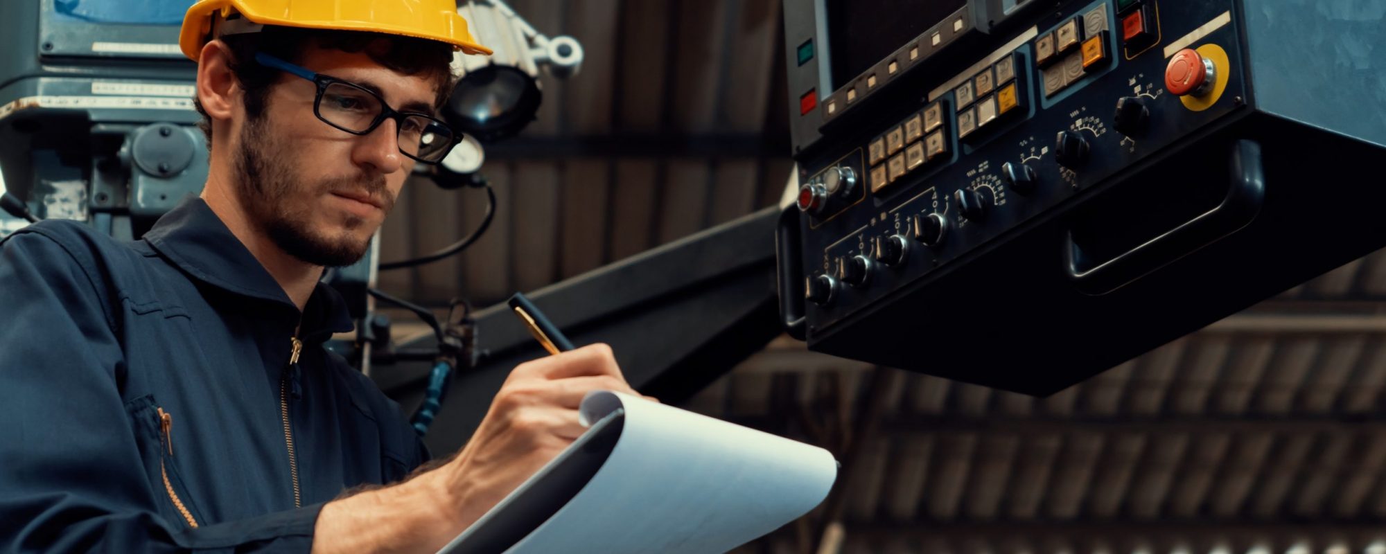 Skillful factory worker working with clipboard to do job procedure checklist . Factory production line occupation quality control concept .